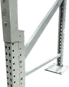 A reinforced metal rack post with a perforated design stands upright, supported by a base plate bolted to the floor. The post features an additional reinforced sleeve that wraps around the bottom portion, providing extra strength and protection against impact. Diagonal support braces are attached to the post, connecting it to another base plate, enhancing stability and rigidity. This setup indicates a repaired or reinforced shelving unit intended to bear significant loads and resist damage in a warehouse or industrial setting.